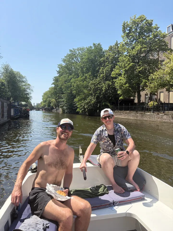Friends relaxing on a canal boat in Amsterdam