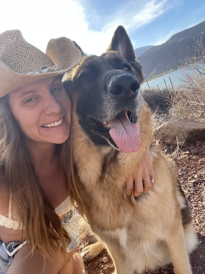 Angela in a cowboy hat taking a selfie with Jack, our German Shepherd
