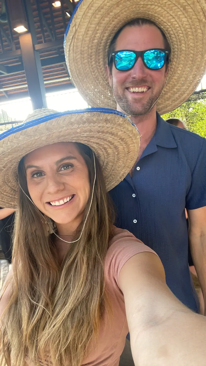 Colin and Angela in wide straw sun hats taking a selfie
