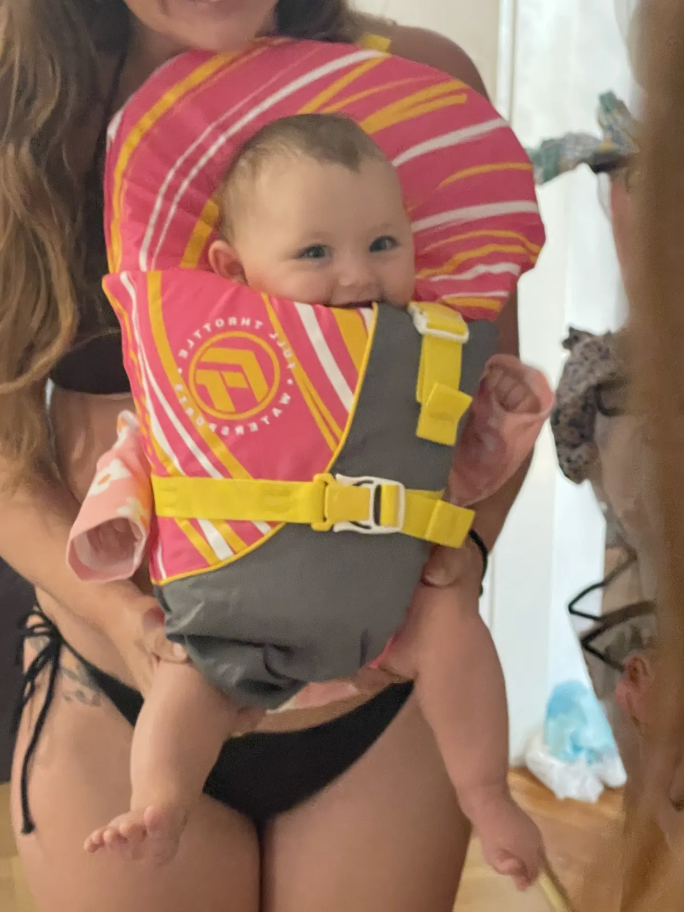Andi in a tiny infant life jacket on the boat