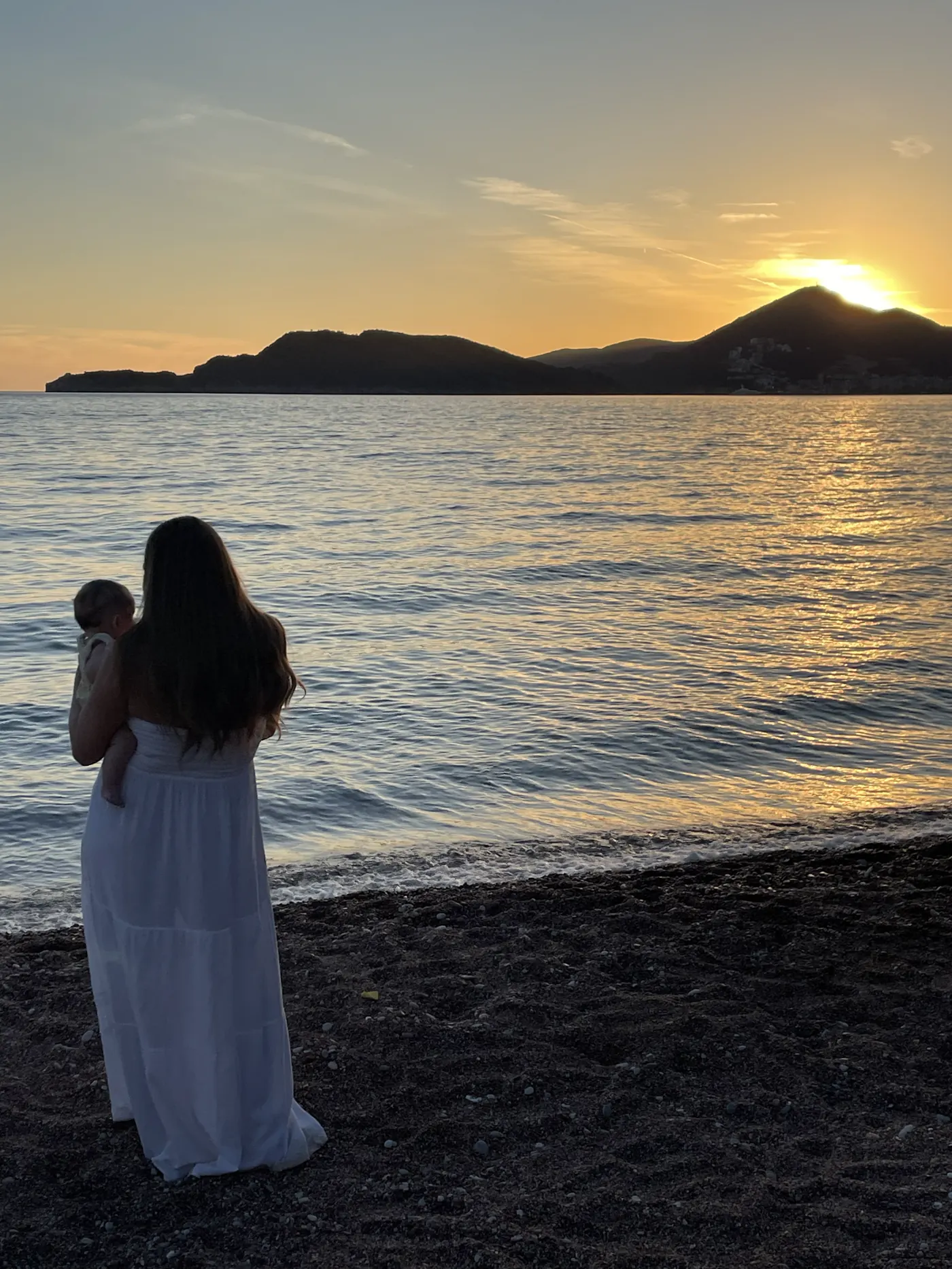 Angela watching the sunset over the sea in Budva