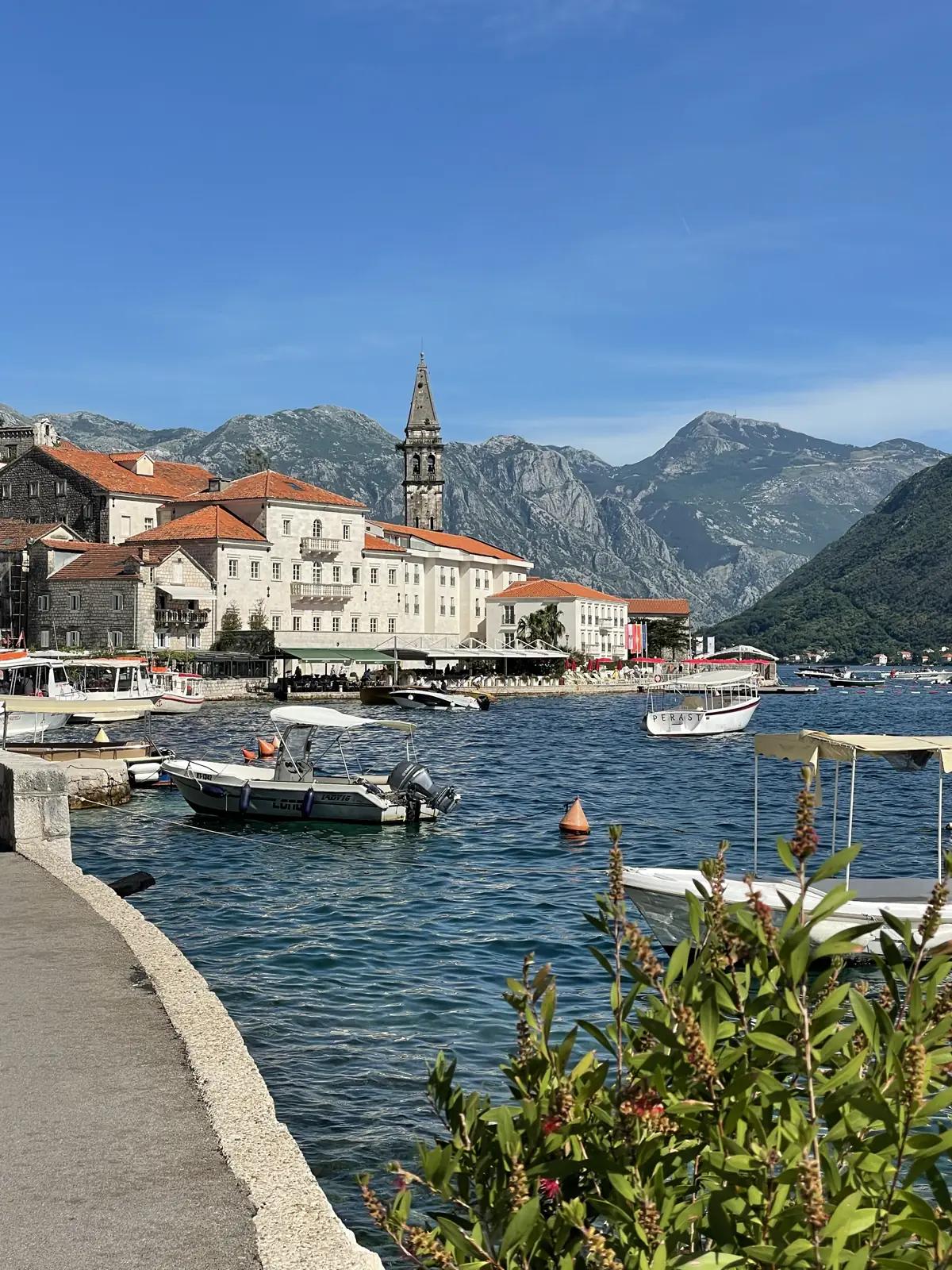 The Perast waterfront with its church tower and boats