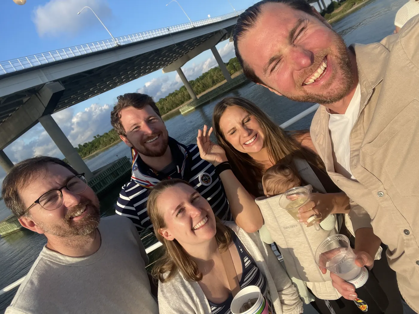 A group selfie with friends at sunset on Charleston Harbor