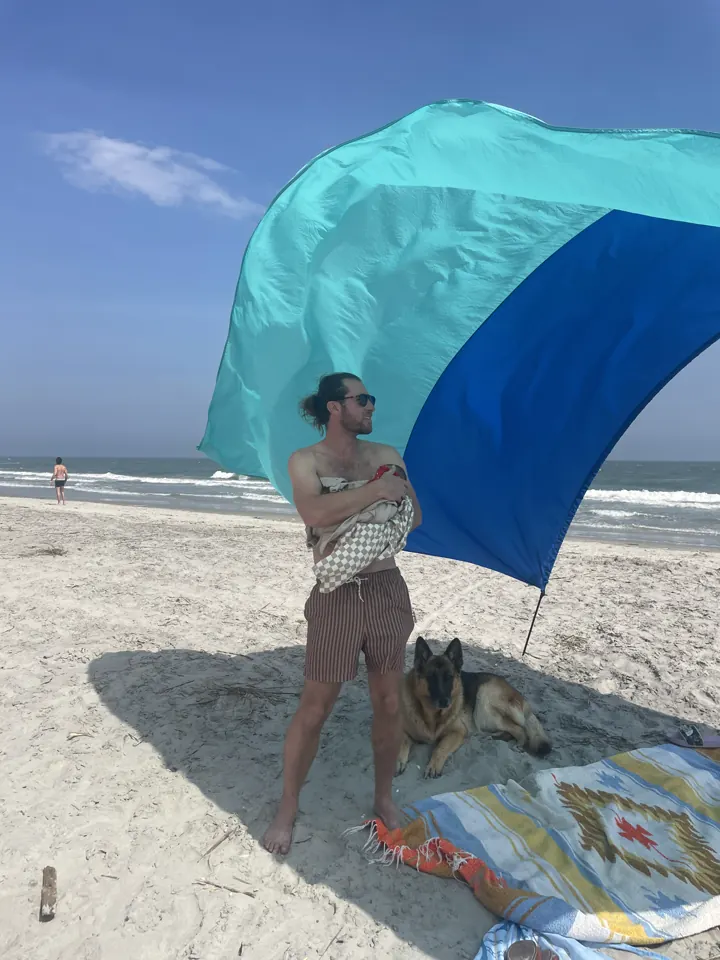A big blue and teal beach umbrella on Folly Beach