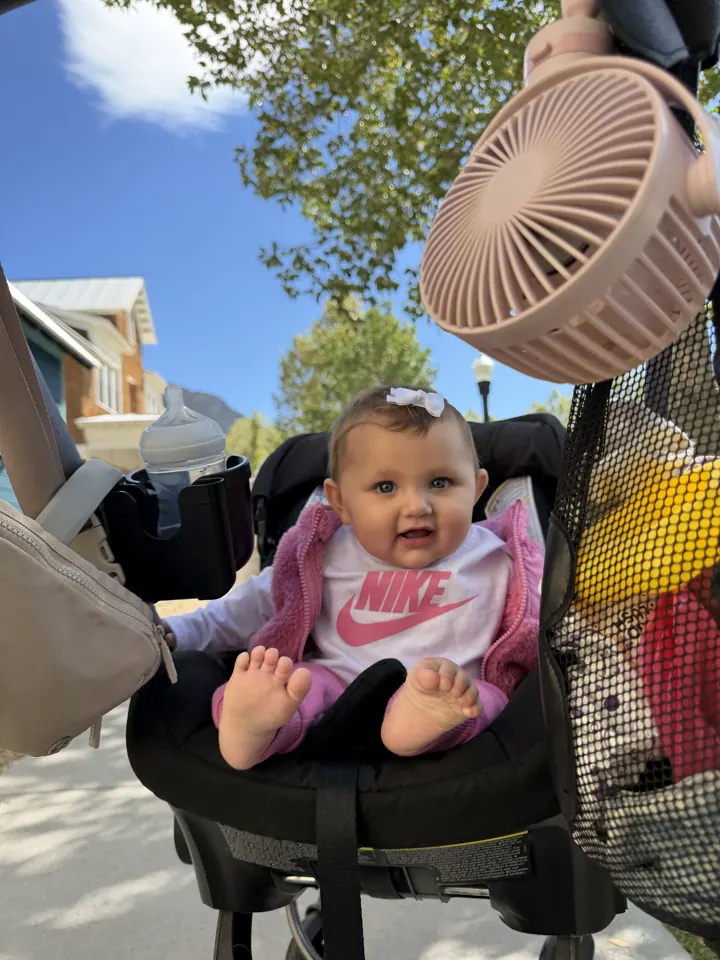 Andi in her stroller with a clip-on fan
