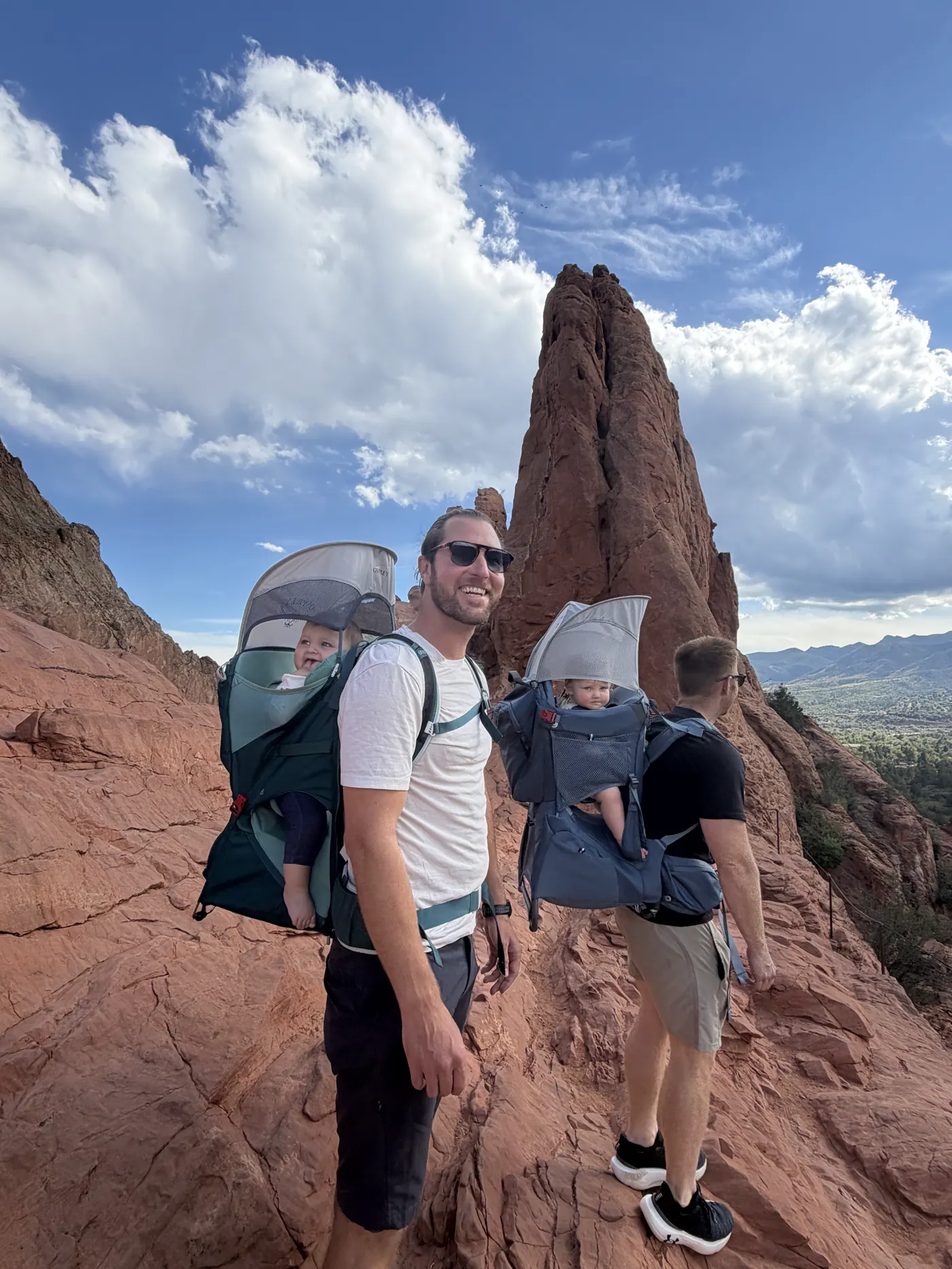 Colin and Angela with the hiking carrier among red rock spires