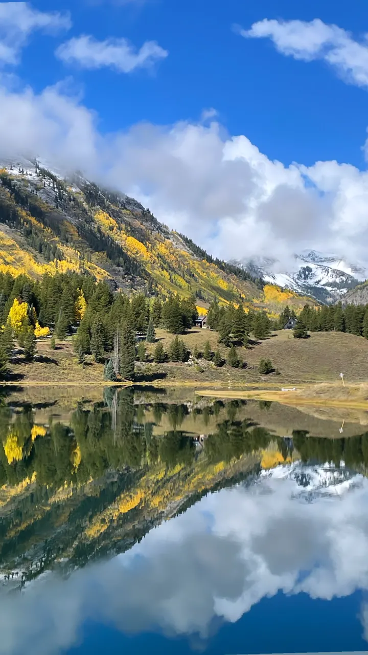 Mountains and fall color reflected in a still lake