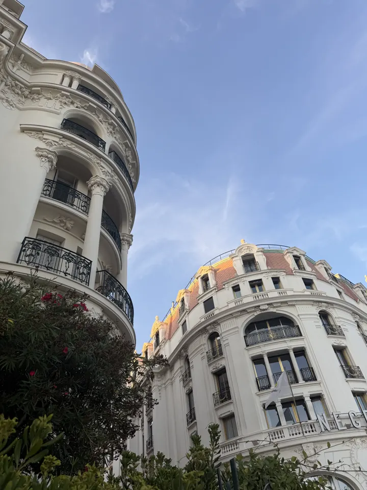 White belle-époque building with a dome against a blue sky