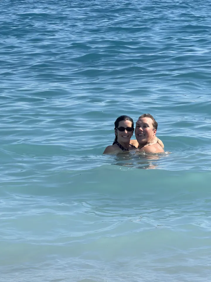 Colin and Angela swimming together in clear blue sea