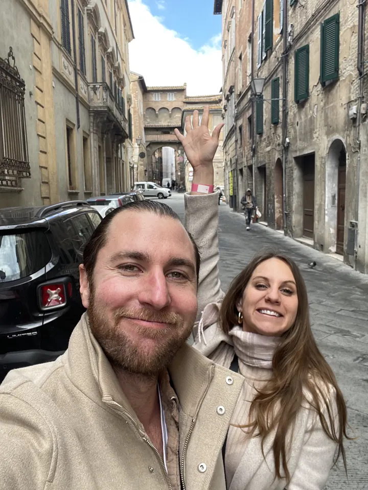 Colin and Angela selfie on a narrow stone street in Siena