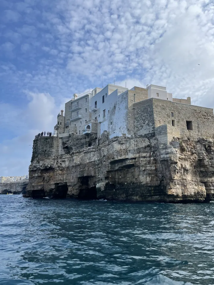 Old town on limestone cliffs above deep blue sea