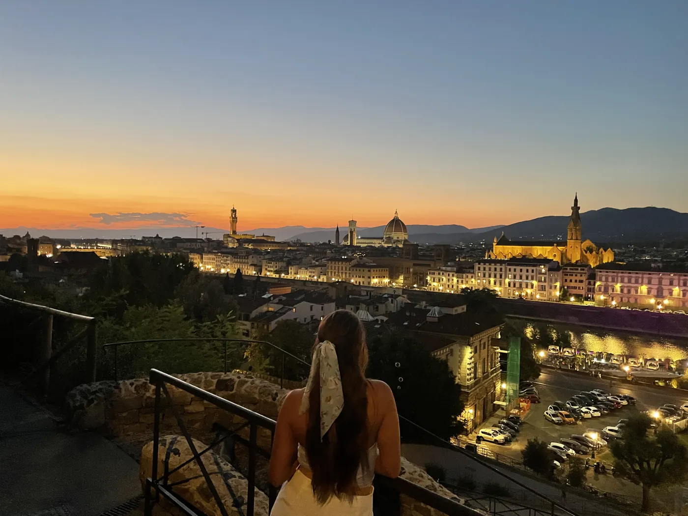Florence skyline at dusk with the Duomo glowing on the horizon