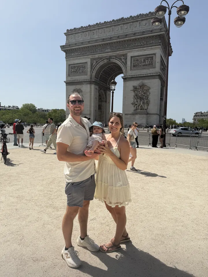 Colin and Angela holding Andi in front of the Arc de Triomphe