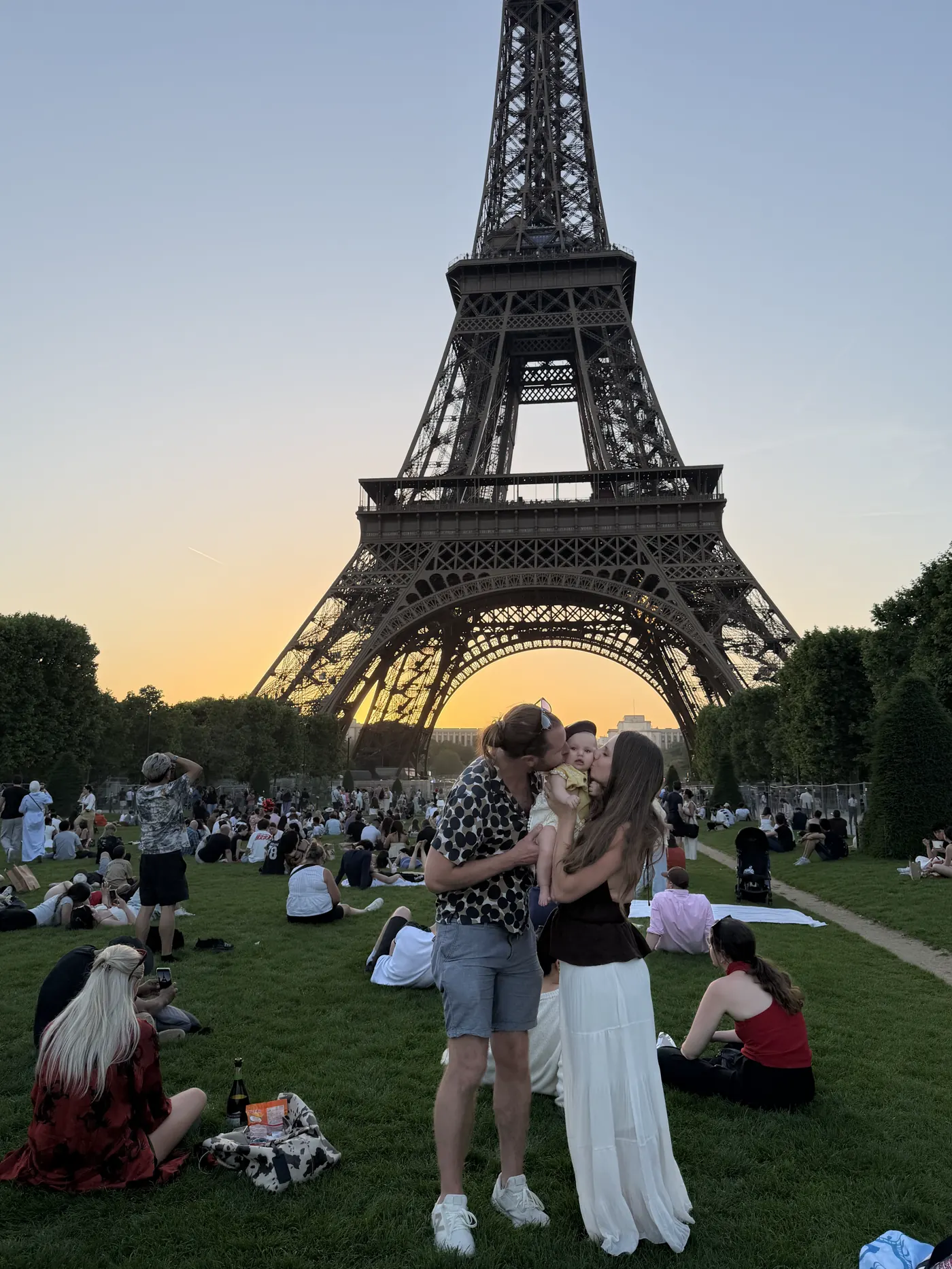 Picnic blankets on the Champ de Mars at sunset under the Eiffel Tower