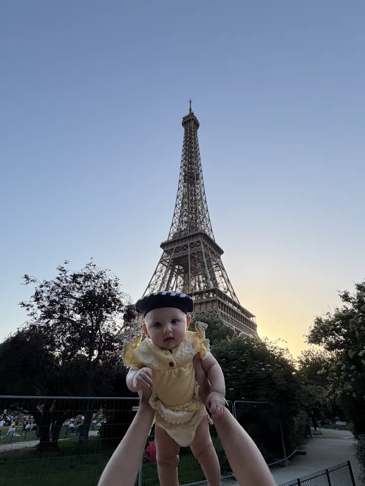 Andi held up in front of the Eiffel Tower