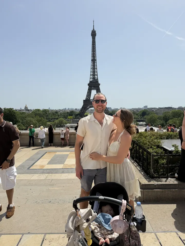 Colin and Angela with the stroller and the Eiffel Tower behind