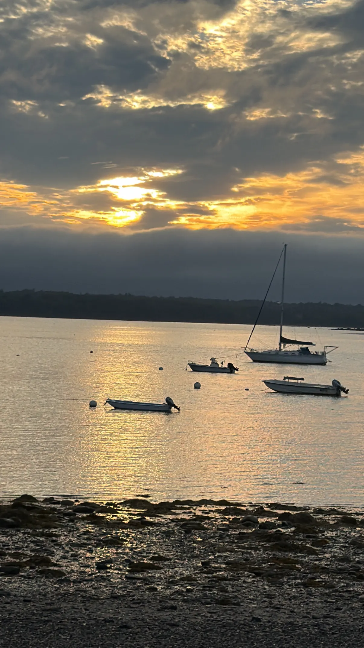 Sunset over boats on the water on the drive up to Bar Harbor