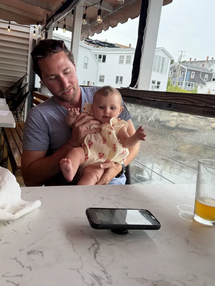 Colin and Andi at a waterfront restaurant table in Boothbay