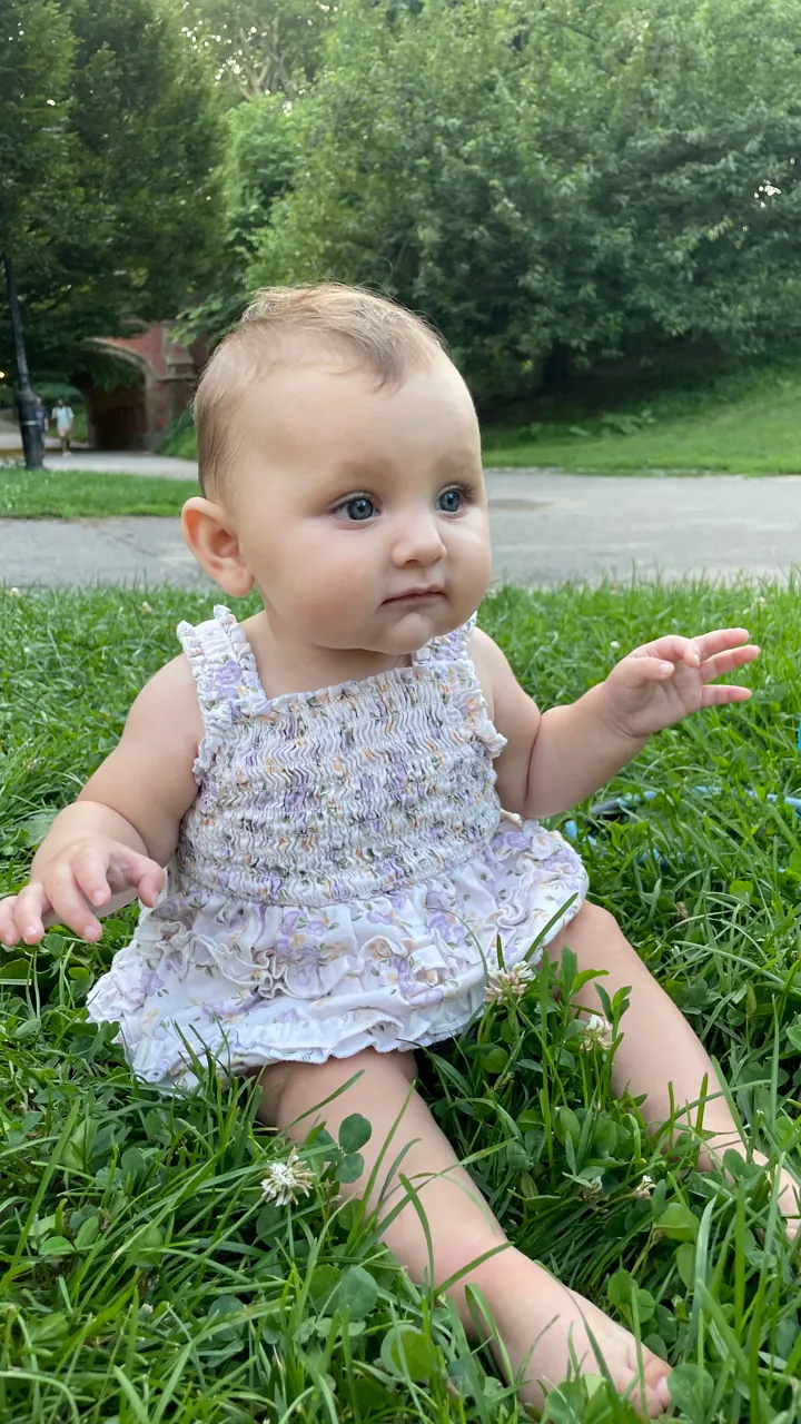 Andi sitting in the grass in Central Park