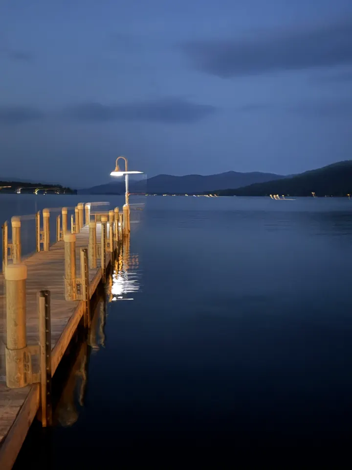 A dock stretching into Lake George at dusk