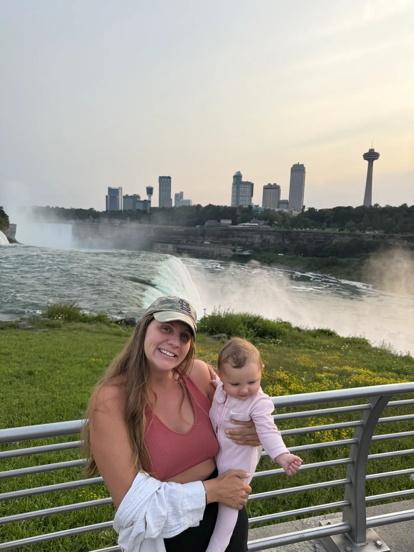 Angela holding Andi at the railing with Niagara Falls behind
