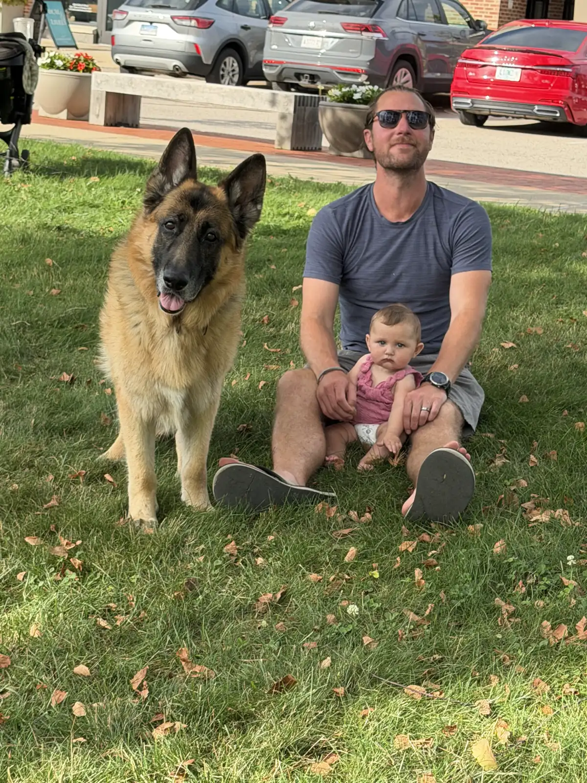 Colin, Andi and Jack sitting in the grass in Conway, New Hampshire