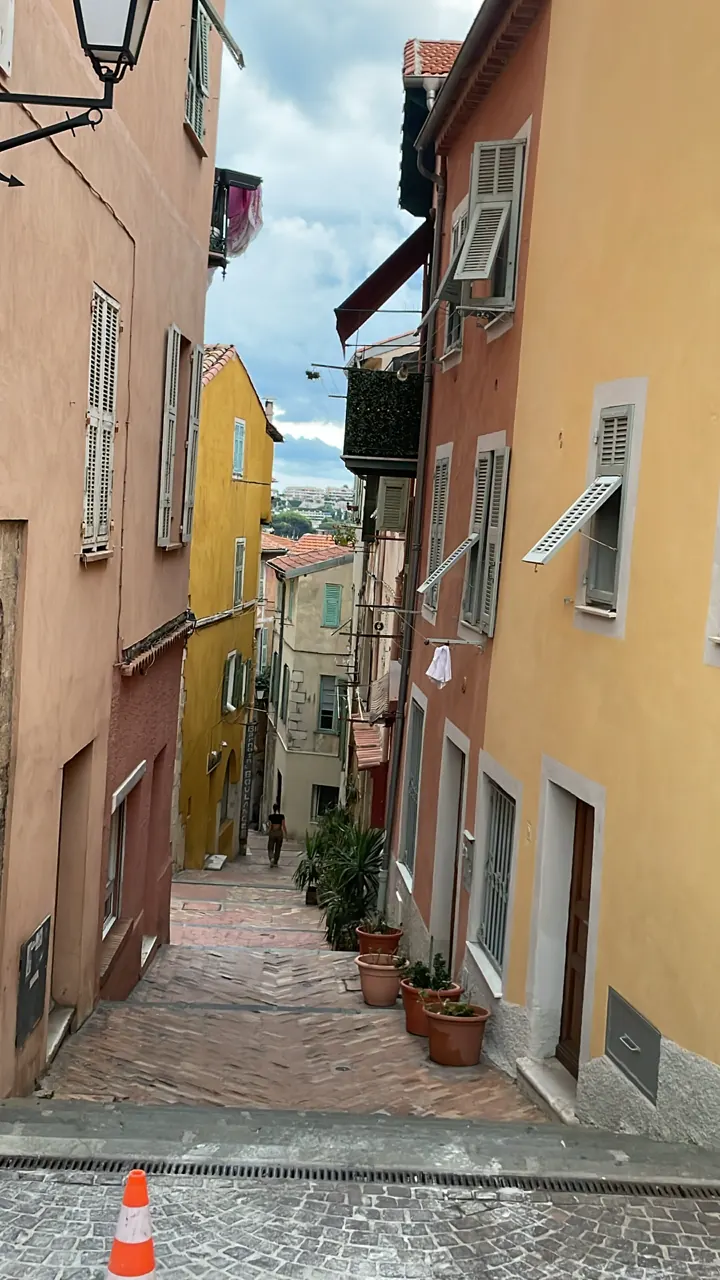 A narrow stepped lane between pastel houses