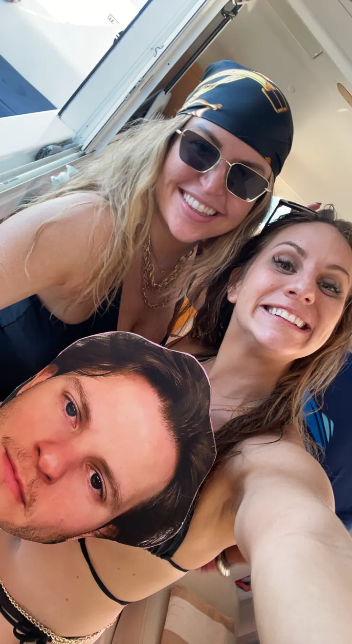 Three friends squeeze into a selfie in the sun
