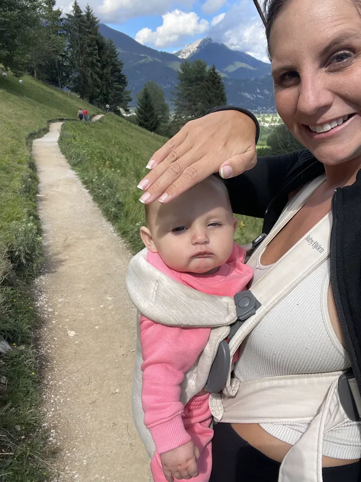Angela with Andi in the carrier on a mountain path