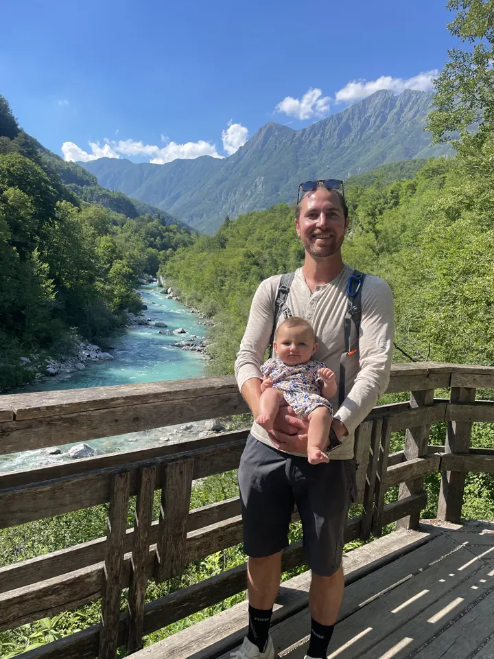 Colin holding Andi on a wooden footbridge over the Soča