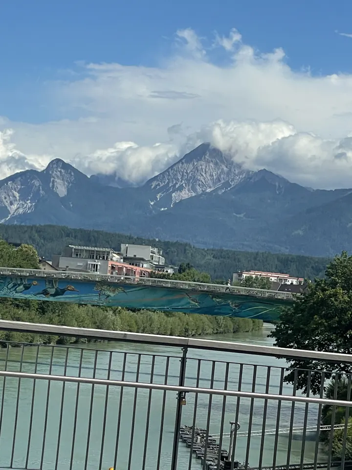 The Drau river in Villach, Austria, with mountains behind