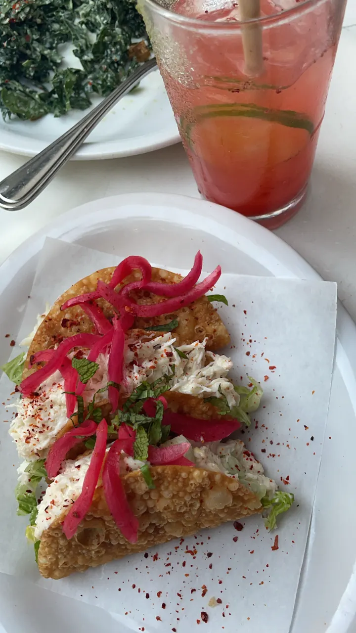 A colorful toast plate with a pink cocktail