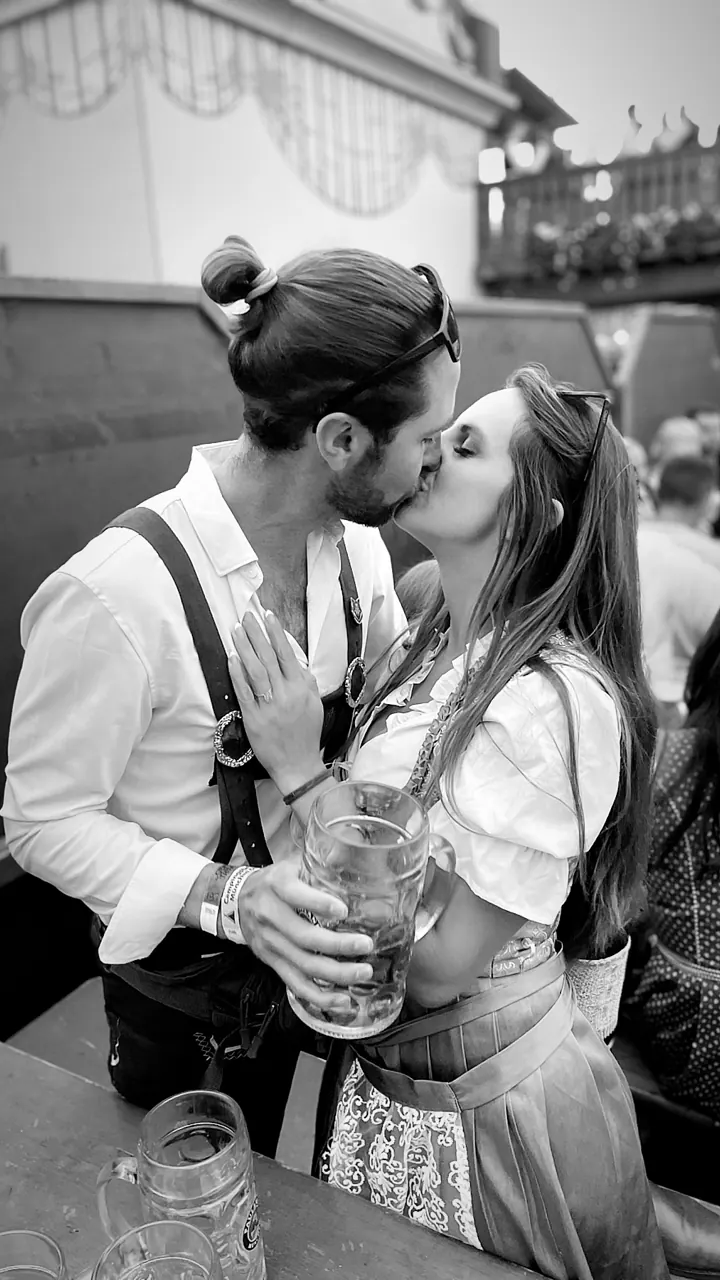 Black-and-white photo of Colin and Angela kissing in costume